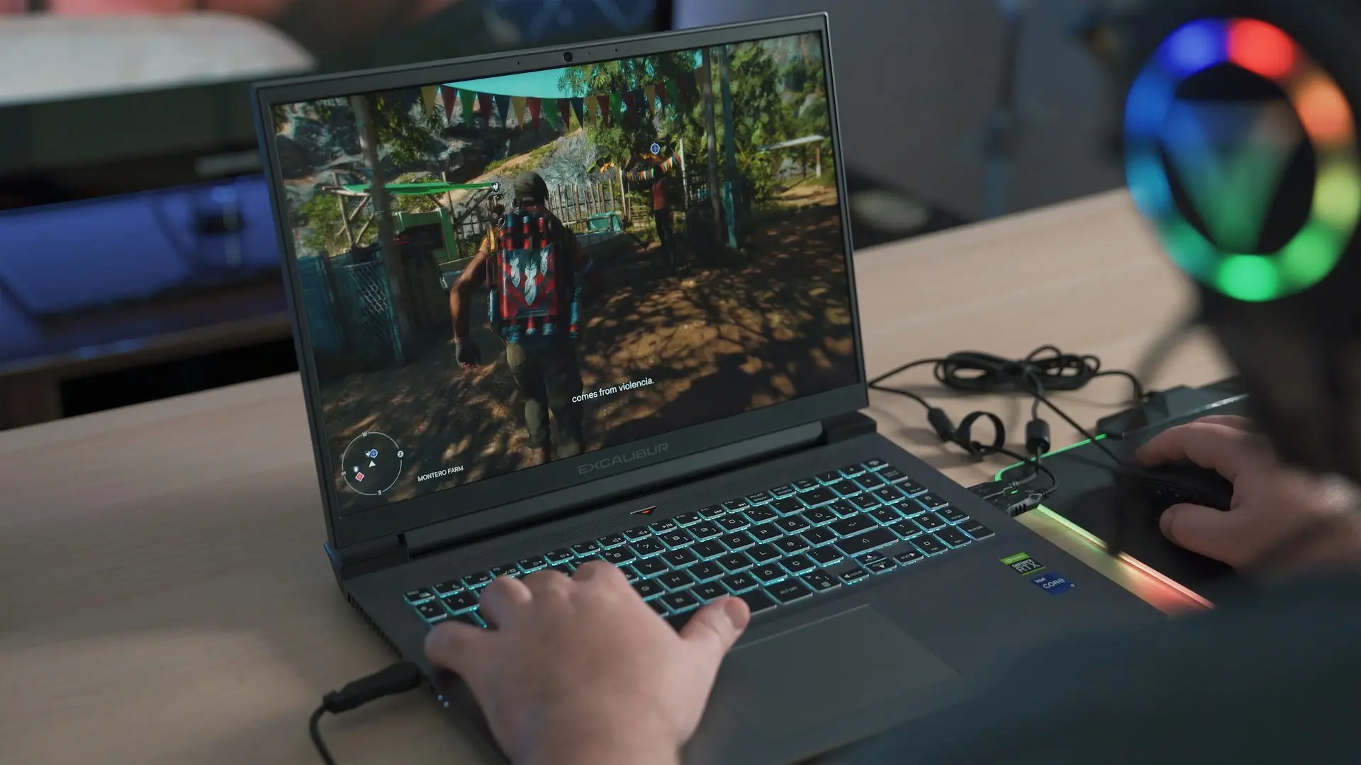 gamer jouant en ligne sur un laptop excalibur avec souris et casque RGB