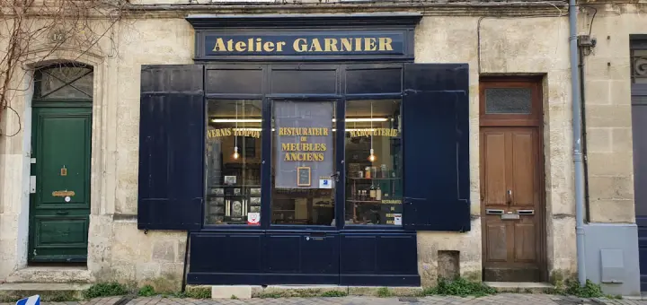 a building with a store front on the corner