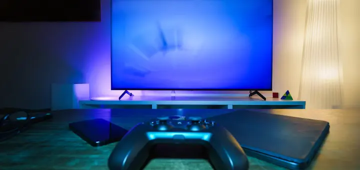 A video game controller sitting in front of a TV