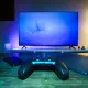 A video game controller sitting in front of a TV