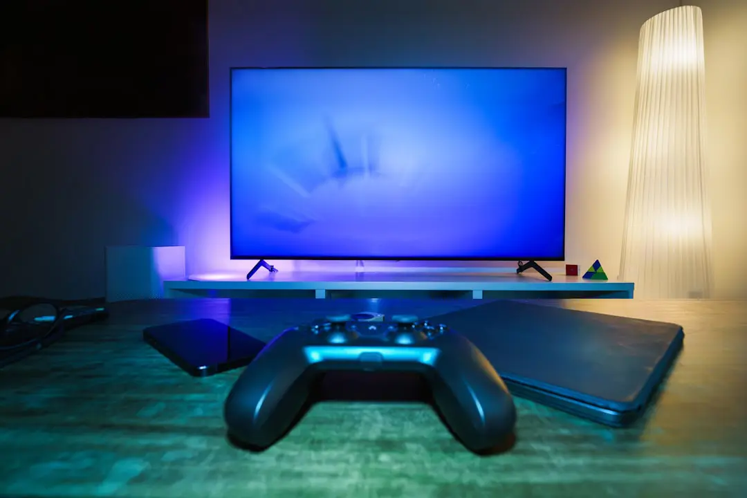 A video game controller sitting in front of a TV