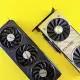 Two modern graphics cards on a bright yellow background, highlighting technology and design.