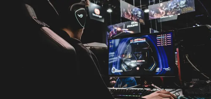 person sitting on gaming chair while playing video game