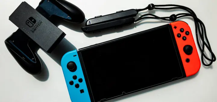 white nintendo switch beside black usb flash drive