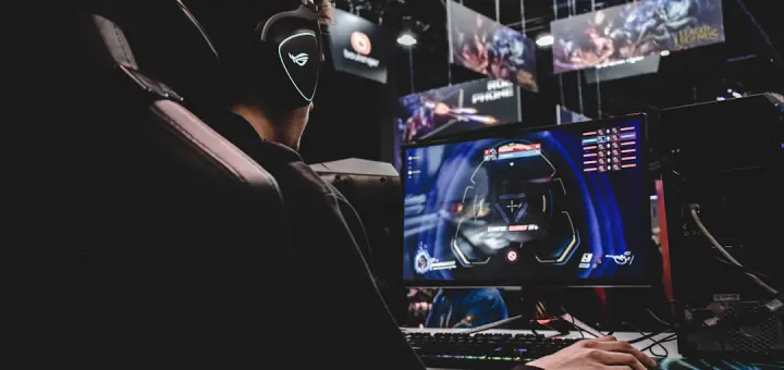 person sitting on gaming chair while playing video game